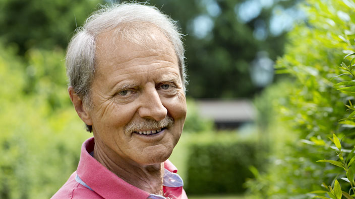 Man smiling in a garden
